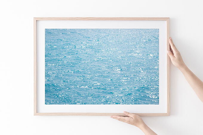 Happy Blues - Sun glitter on water art print in natural frame by Cattie Coyle Photography