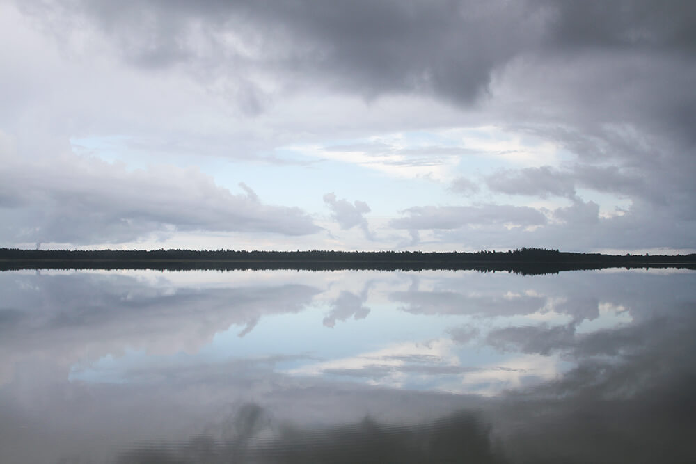 Storm clouds and calm water at Tingstäde Träsk, Gotland, Sweden, by Cattie Coyle Photography